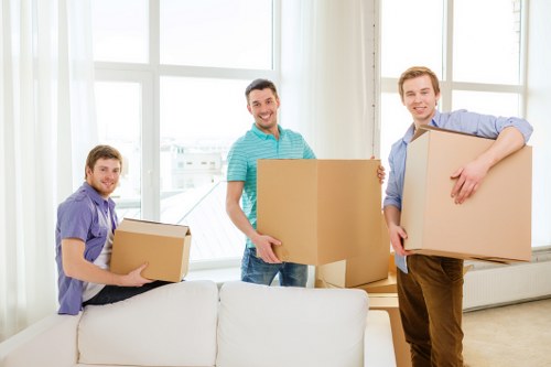 Loading household furniture into a van for a Harrowonthehill removal job