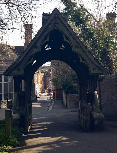 A historic red-brick building with a stepped gable roofline and multiple windows, located on Church Hill in Harrow Weald, viewed from a street with a stone retaining wall and iron fence in the foregro